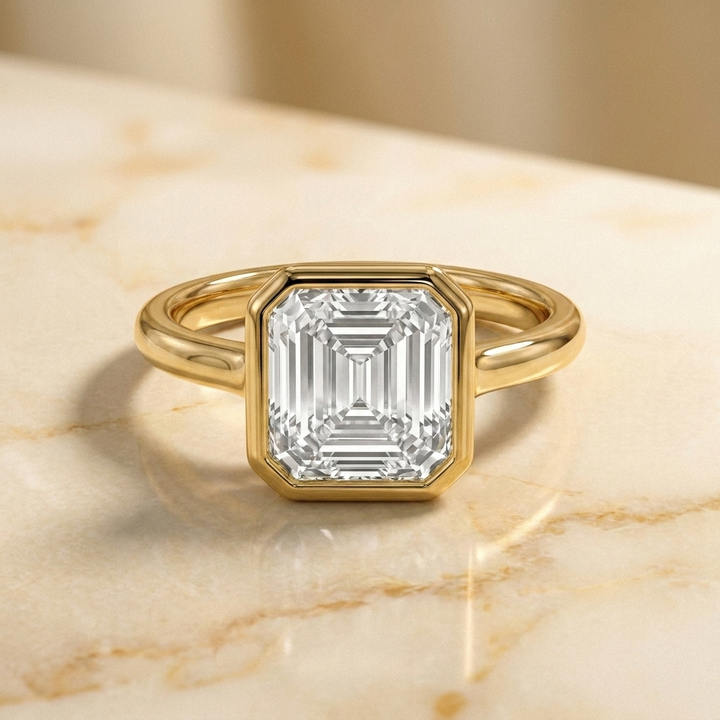 The Agnes Select bezel solitaire square emerald engagement ring in 18k yellow gold — front view — RockHer