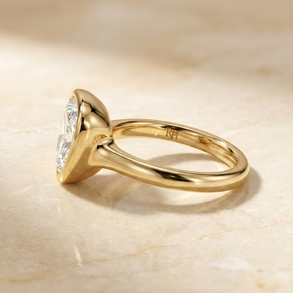 The Agnes Select bezel solitaire shield engagement ring in 18k yellow gold — side profile — RockHer
