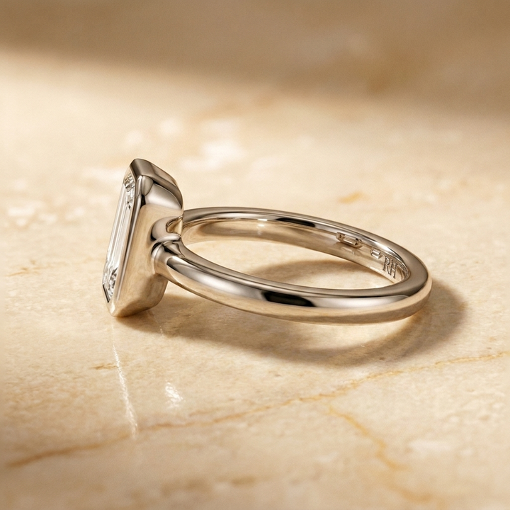 The Agnes Select bezel solitaire tapered baguette engagement ring in platinum — side profile — RockHer