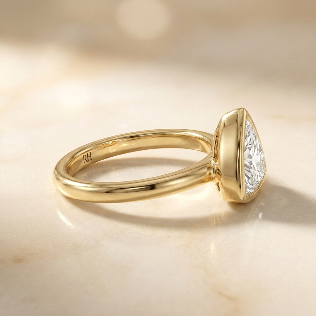The Agnes Select bezel solitaire trillion engagement ring in 18k yellow gold — side profile — RockHer
