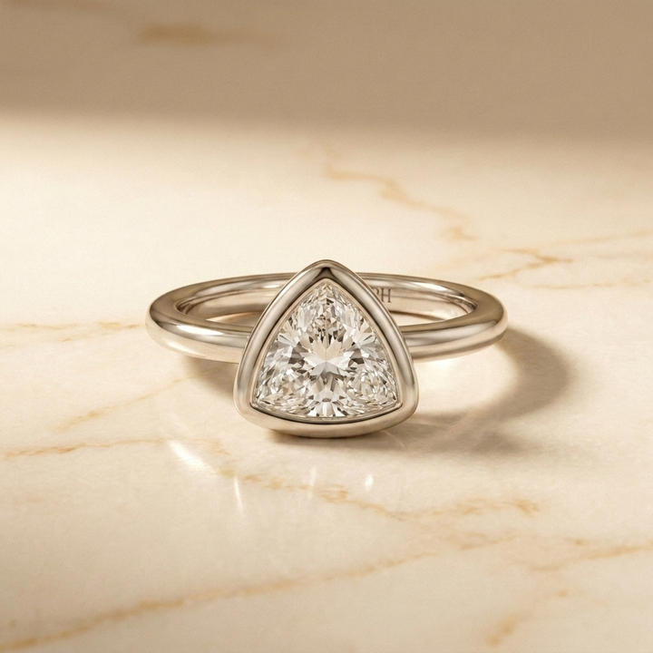 The Agnes Select bezel solitaire trillion engagement ring in 18k white gold — front view — RockHer