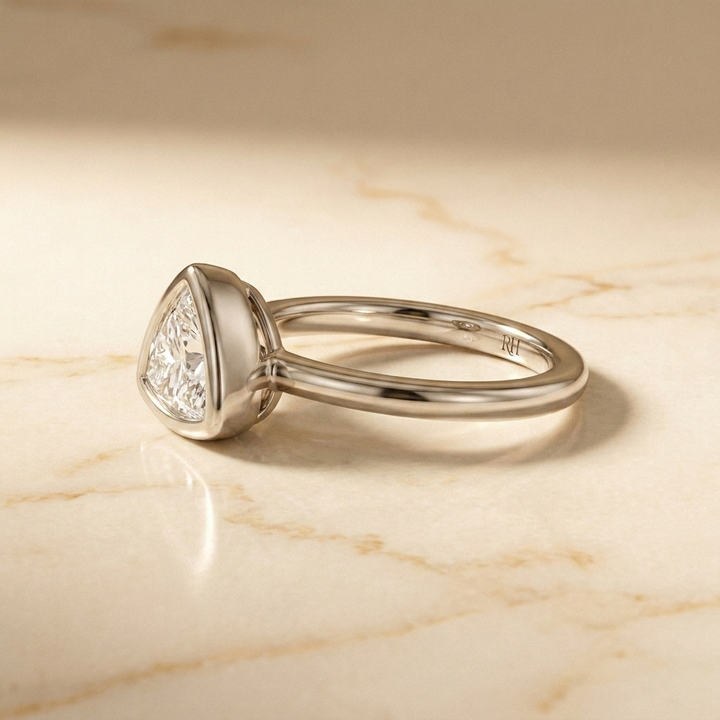 The Agnes Select bezel solitaire trillion engagement ring in 18k white gold — side profile — RockHer