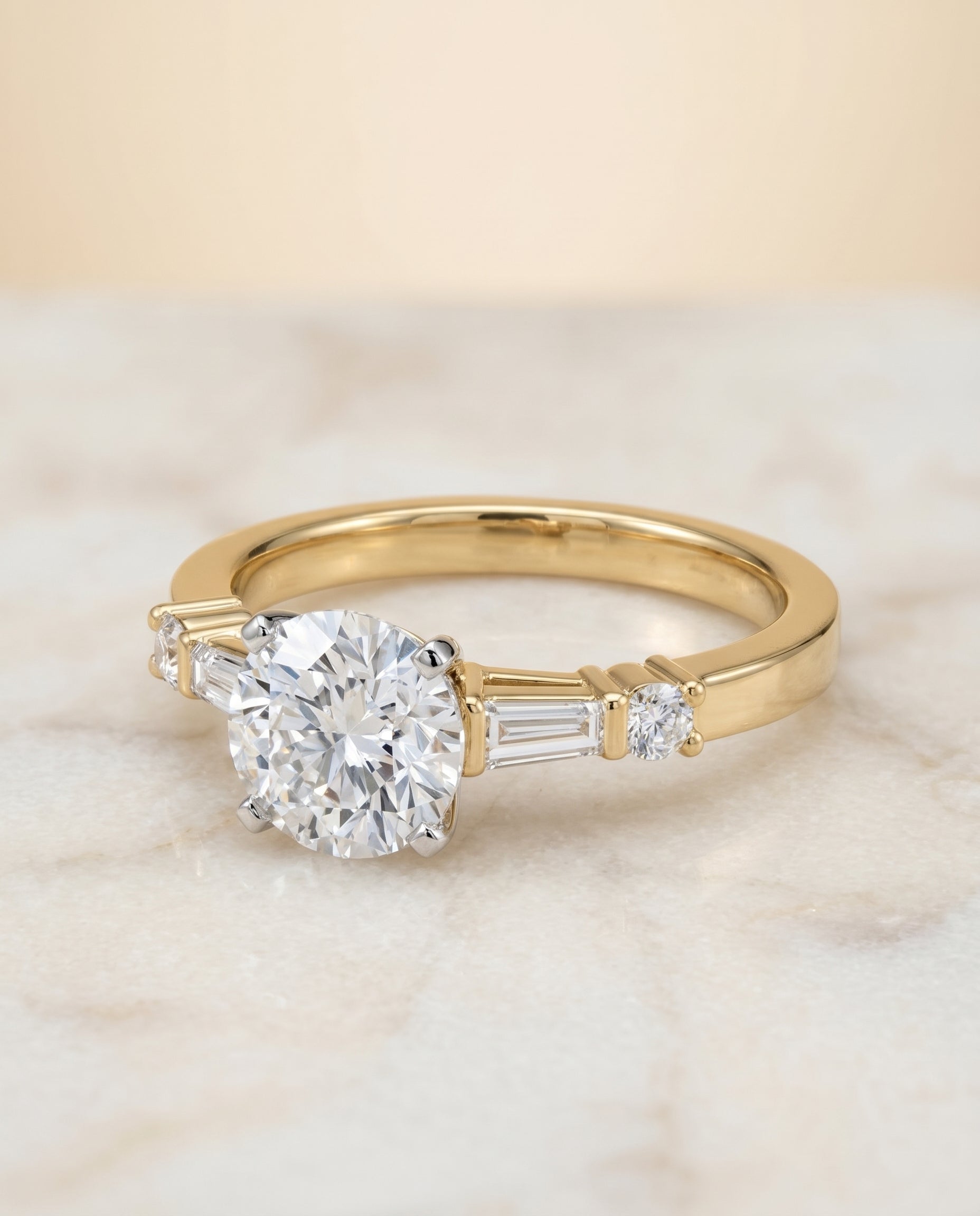 Round Brilliant, Baguette and Round Side Stone, in 18K Yellow Gold – side profile | RockHer