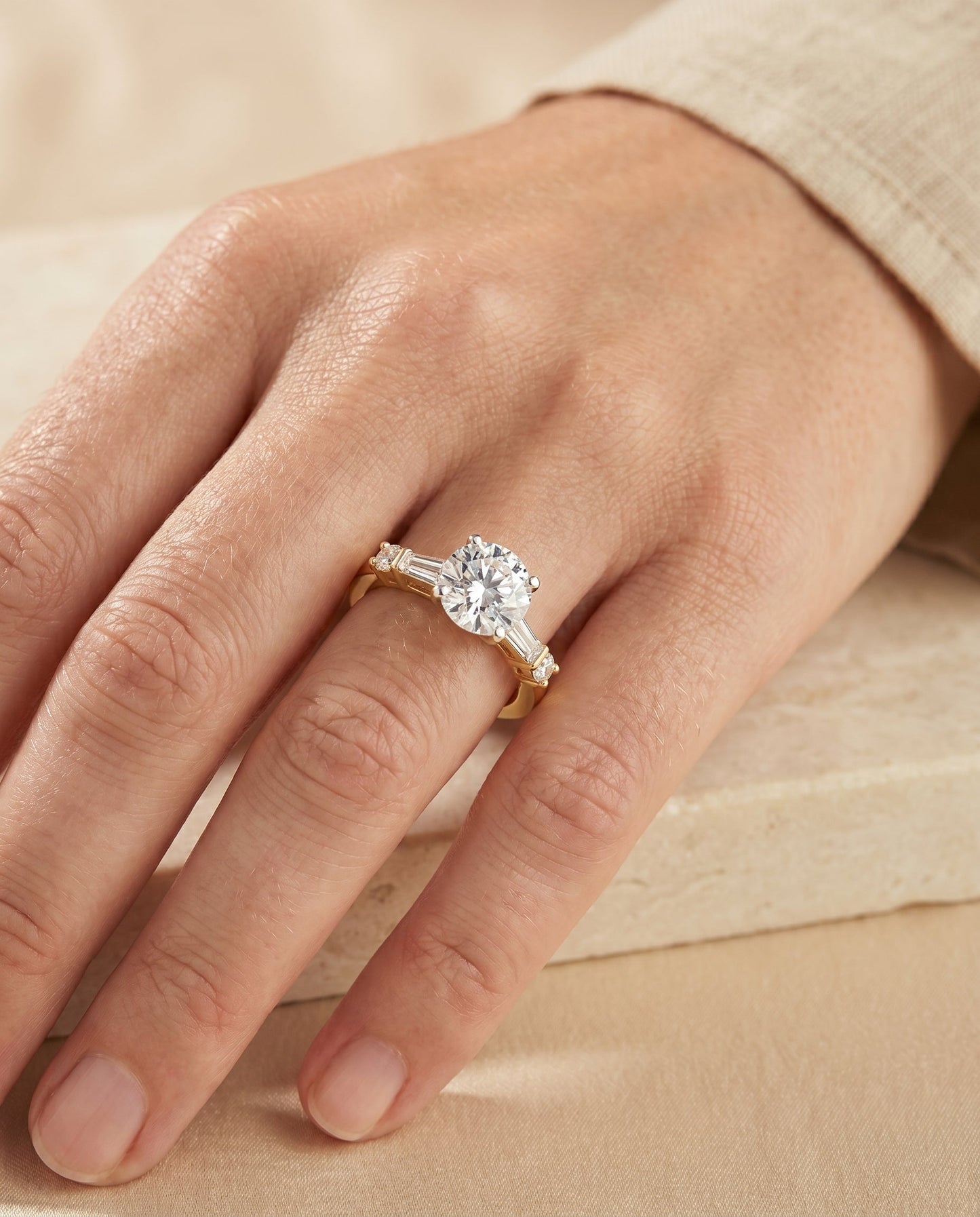 Round Brilliant, Baguette and Round Side Stone, in 18K Yellow Gold – lifestyle shot | RockHer