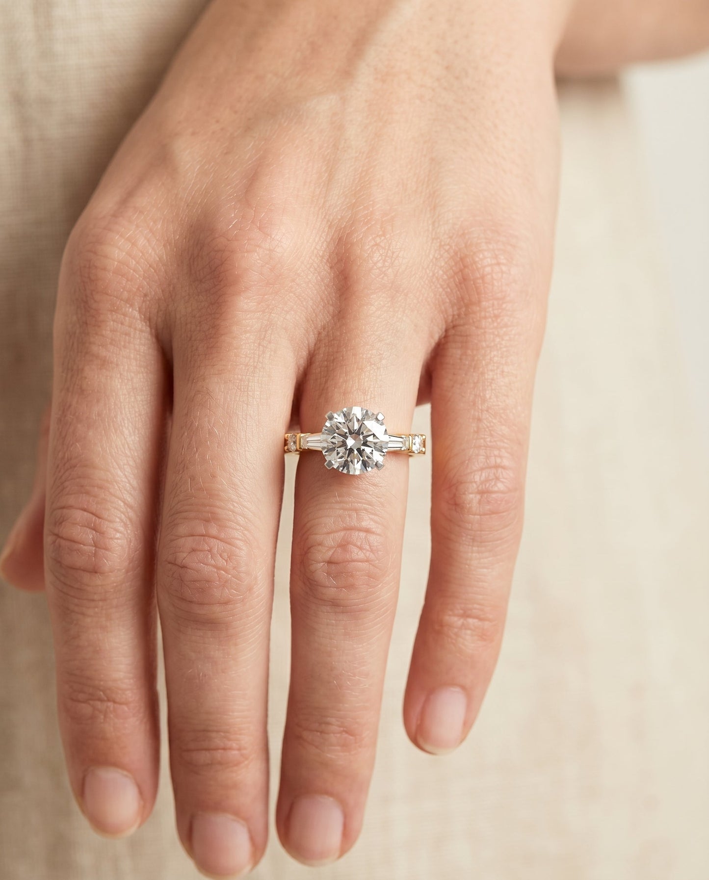 Round Brilliant, Baguette and Round Side Stone, in 18K Yellow Gold – lifestyle shot | RockHer