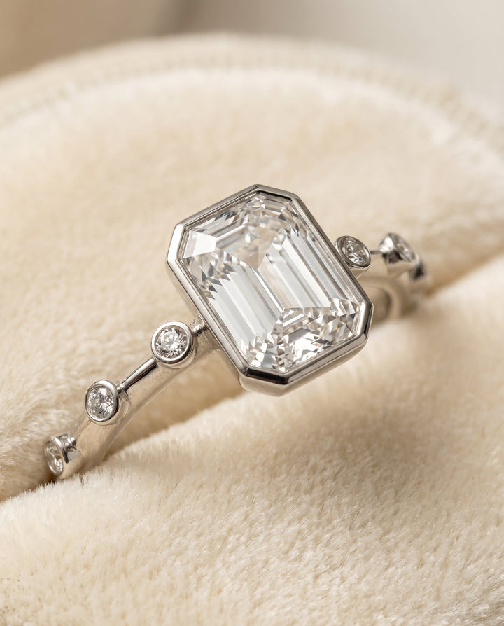 ตัวเรือนแหวนหมั้น Brandi Bezel Solitaire สำหรับเพชรทรงมรกตในแพลทินัม