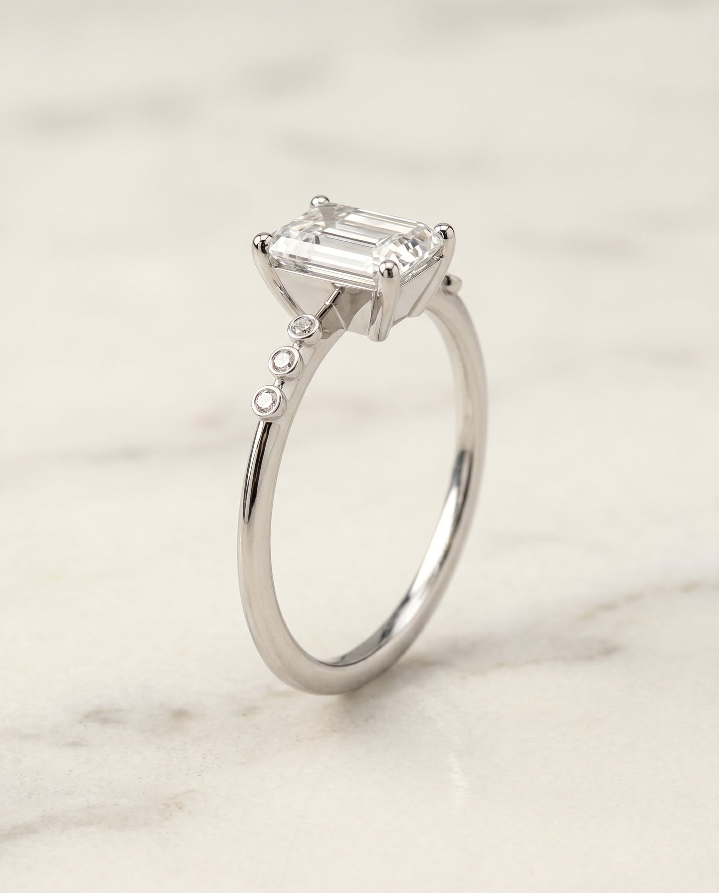 The Peggy Bezel Solitaire Engagement Ring Setting for Emerald Cut Diamonds in Platinum