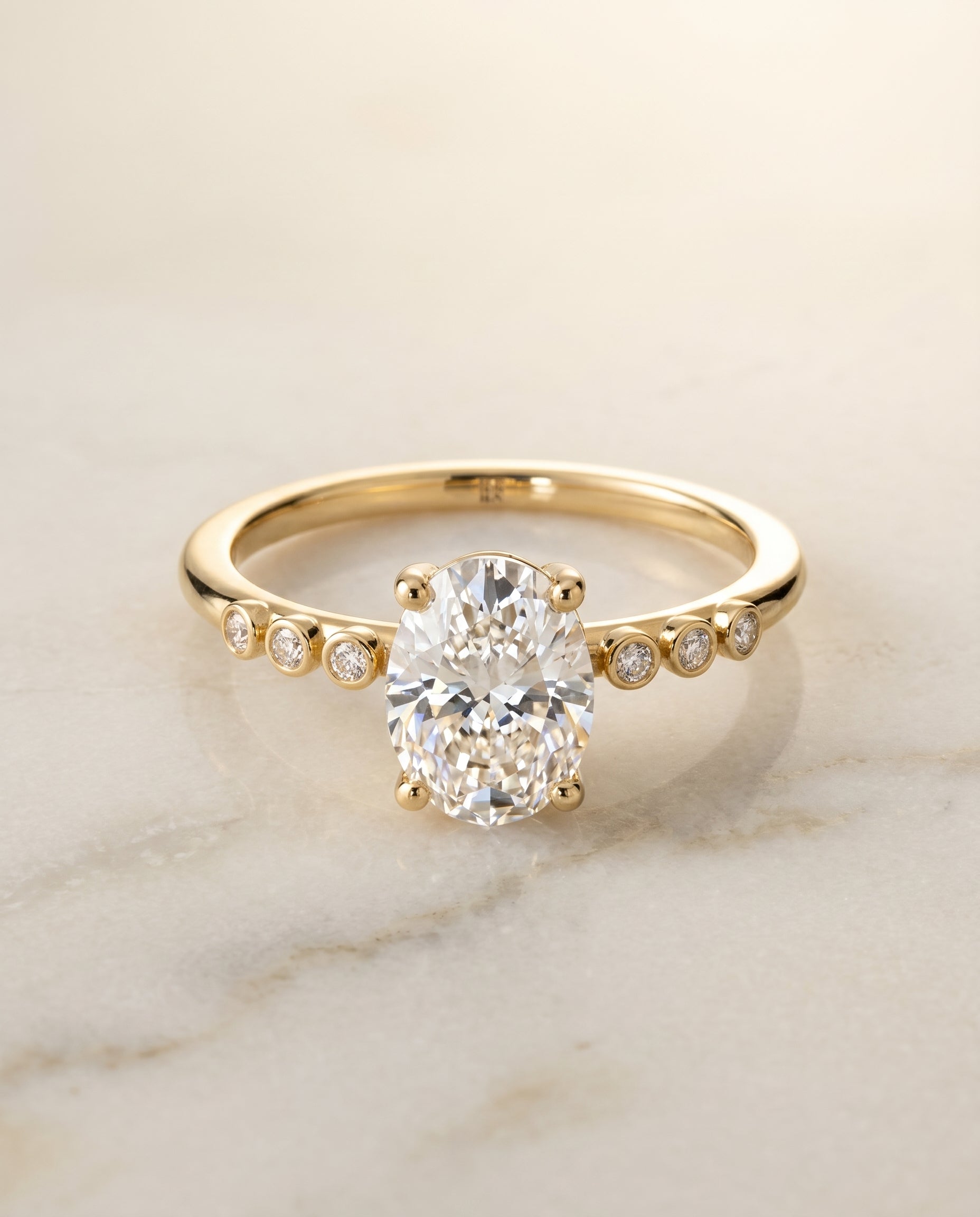 Peggy Select Bezel Accent Solitaire Oval in 18K Yellow Gold – view 1