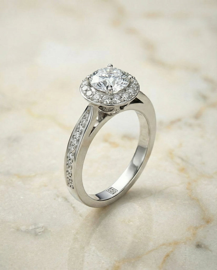 Round Brilliant, Channel Row Pavé Halo, in Platinum, prong setting – angled view | RockHer