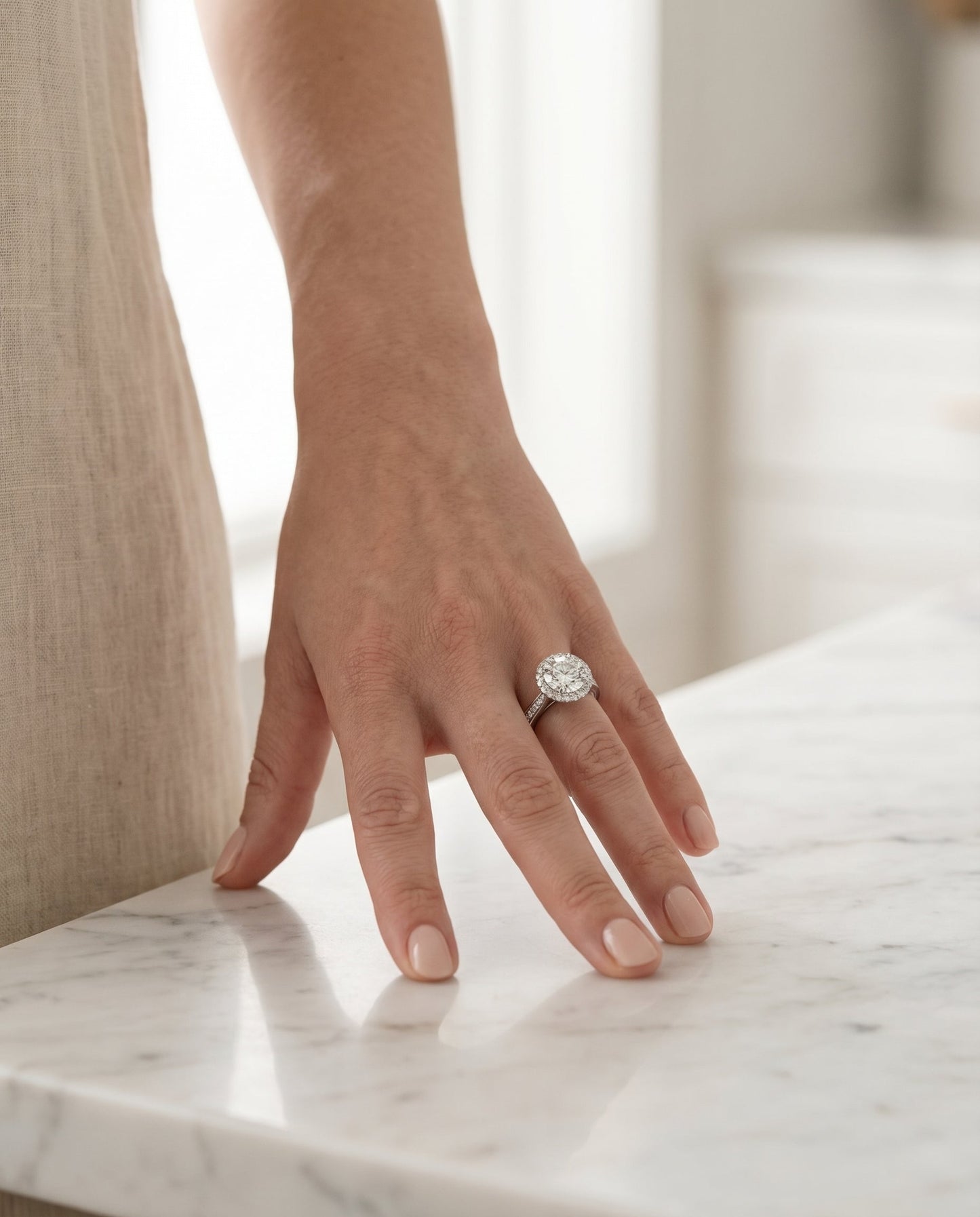 Round Brilliant, Channel Row Pavé Halo, in 18K White Gold, prong setting – lifestyle shot | RockHer
