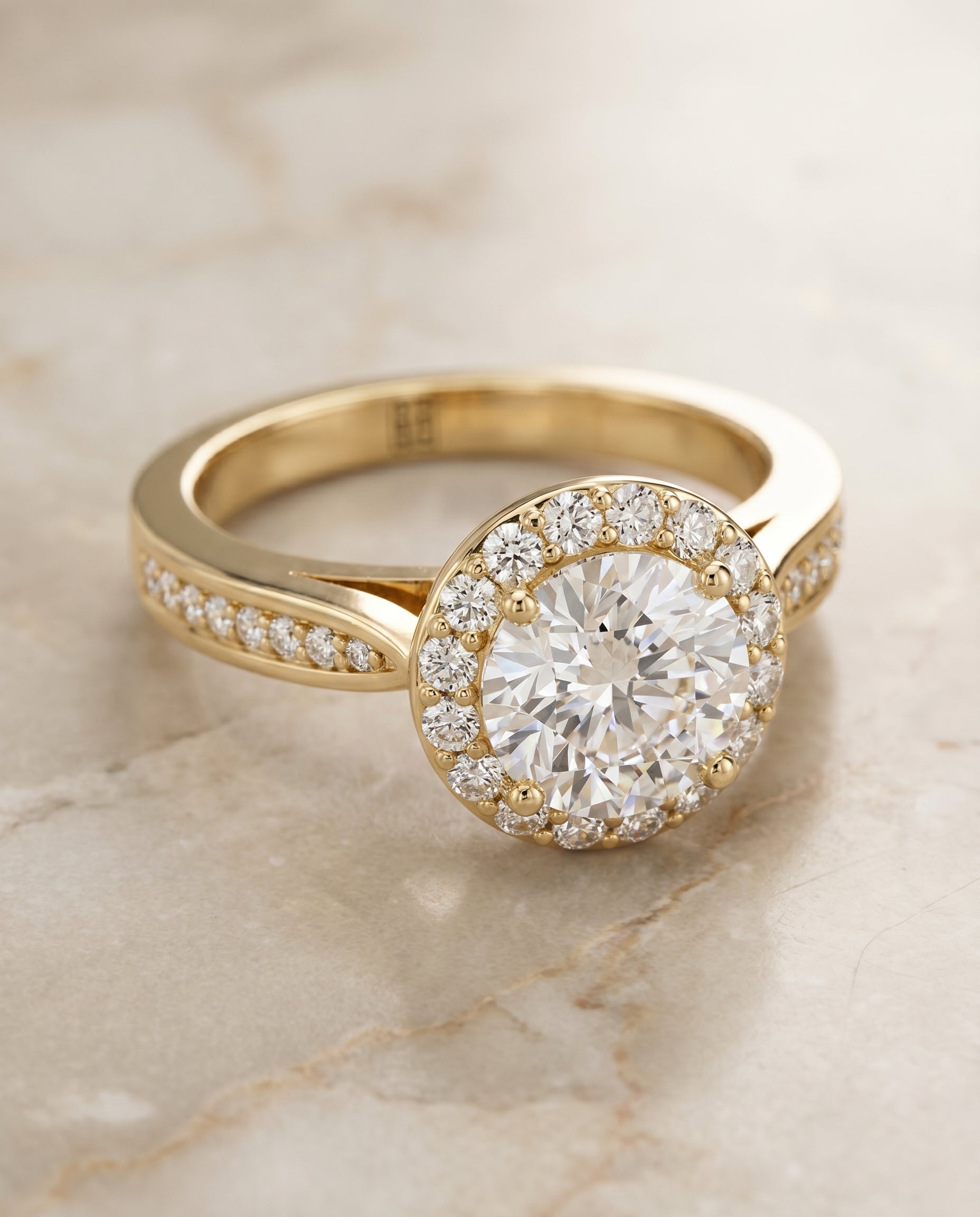 Round Brilliant, Channel Row Pavé Halo, in 18K Yellow Gold, prong setting – angled view | RockHer