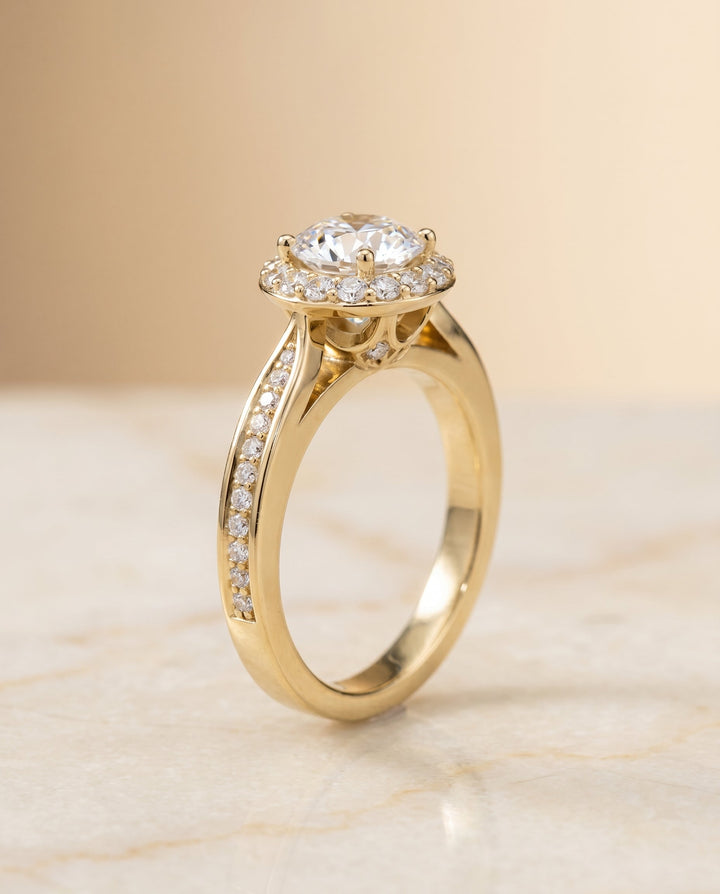 Round Brilliant, Channel Row Pavé Halo, in 18K Yellow Gold, prong setting – front view | RockHer