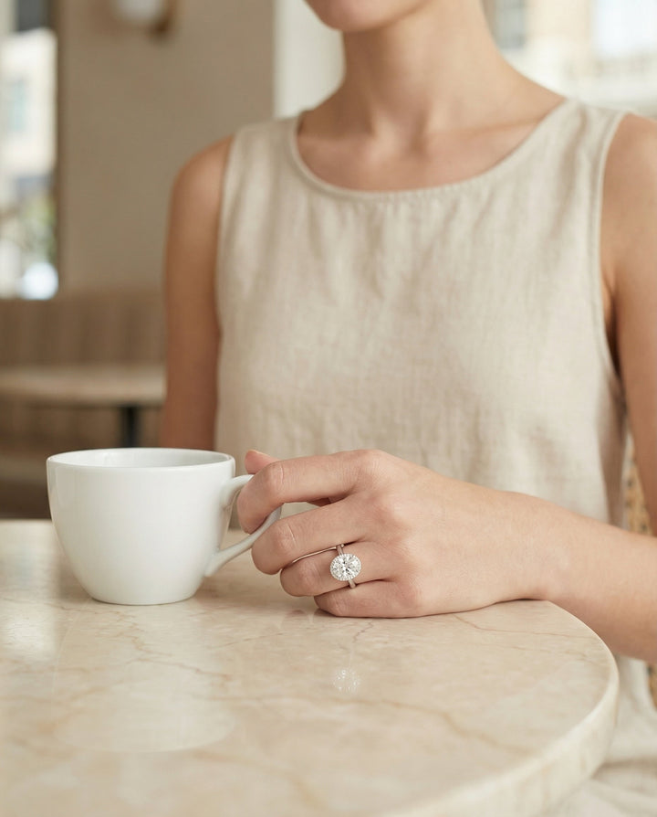 Classic Shared Prong Halo Oval, in Platinum, pave setting – lifestyle shot | RockHer