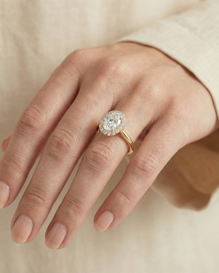 Etta Select classic shared prong halo oval oval ring in 14K Yellow Gold — on hand angled — RockHer