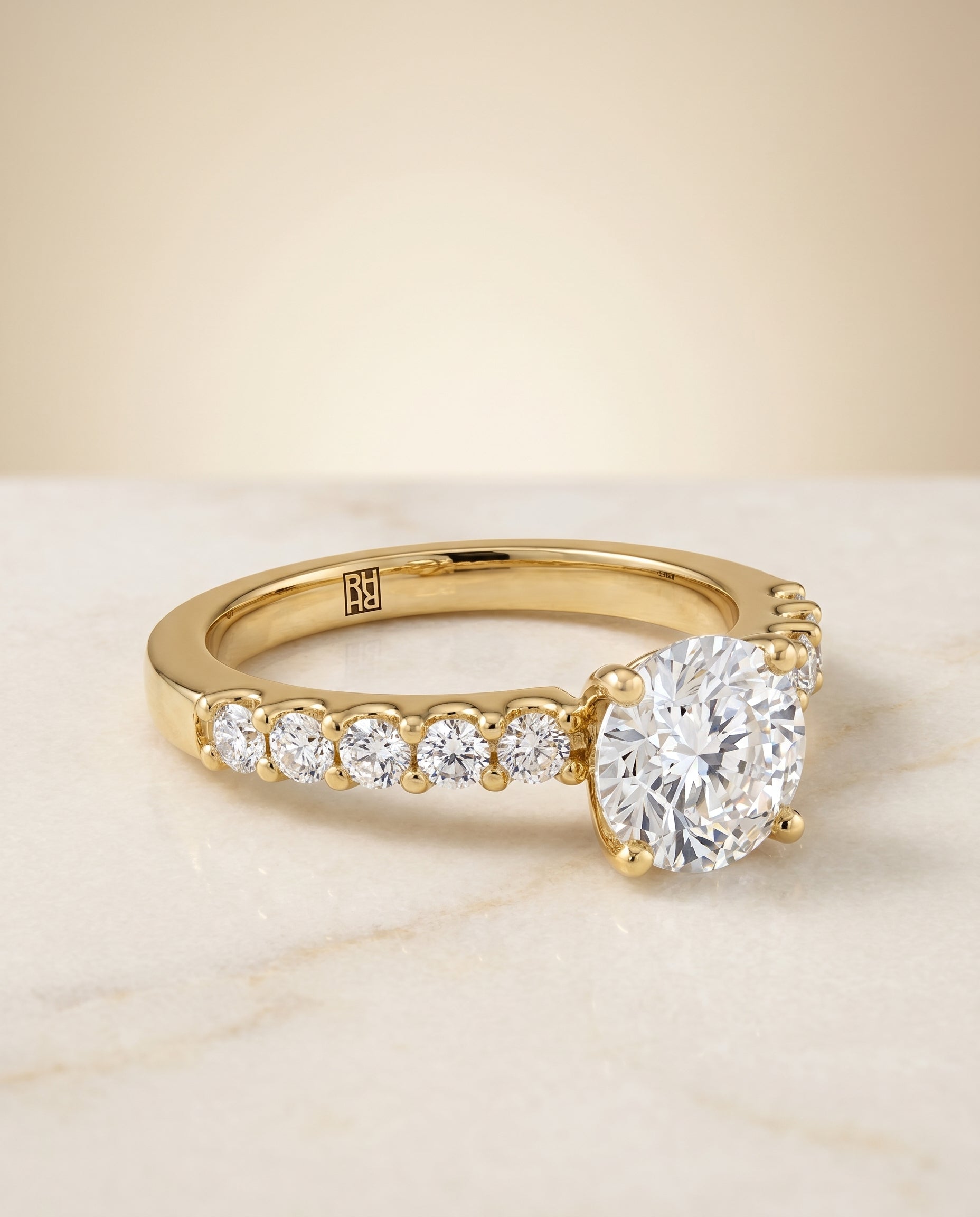 Round Brilliant, Classic Shared Prong Linear Pavé, in 18K Yellow Gold – angled view | RockHer