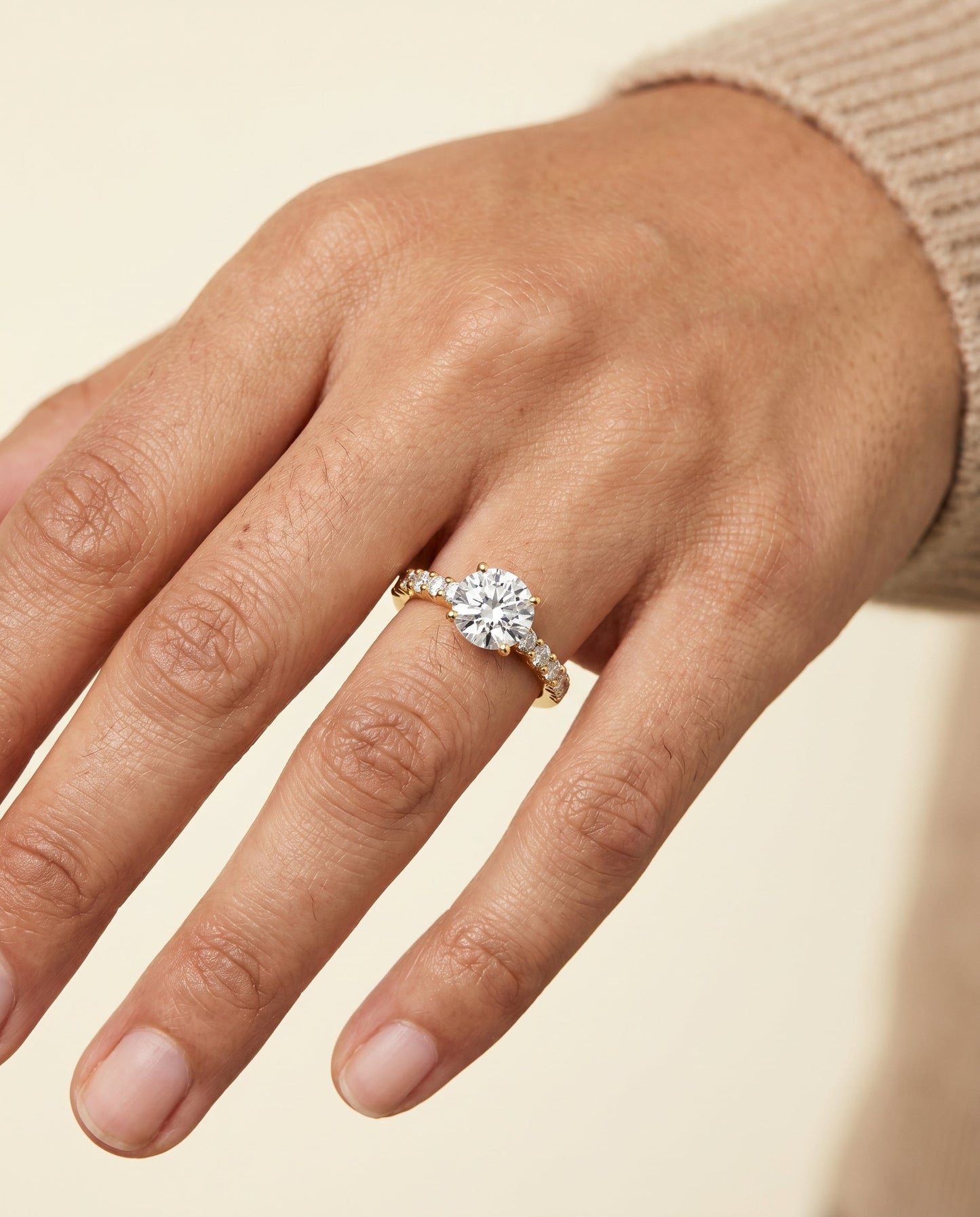 Round Brilliant, Classic Shared Prong Linear Pavé, in 18K Yellow Gold – lifestyle shot | RockHer