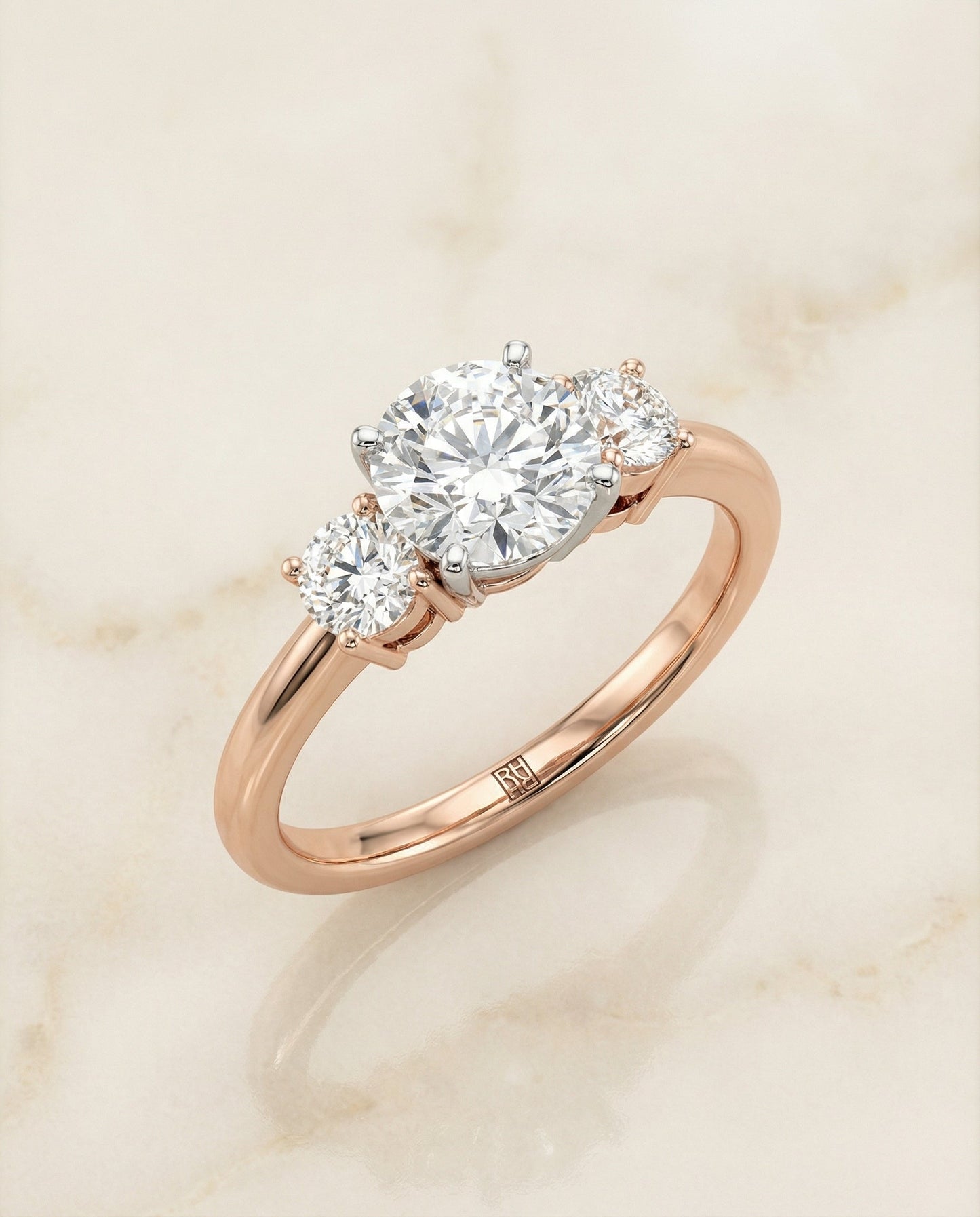 Round Brilliant, Classic Three Stone Round, in 14K Rose Gold, prong setting – angled view | RockHer