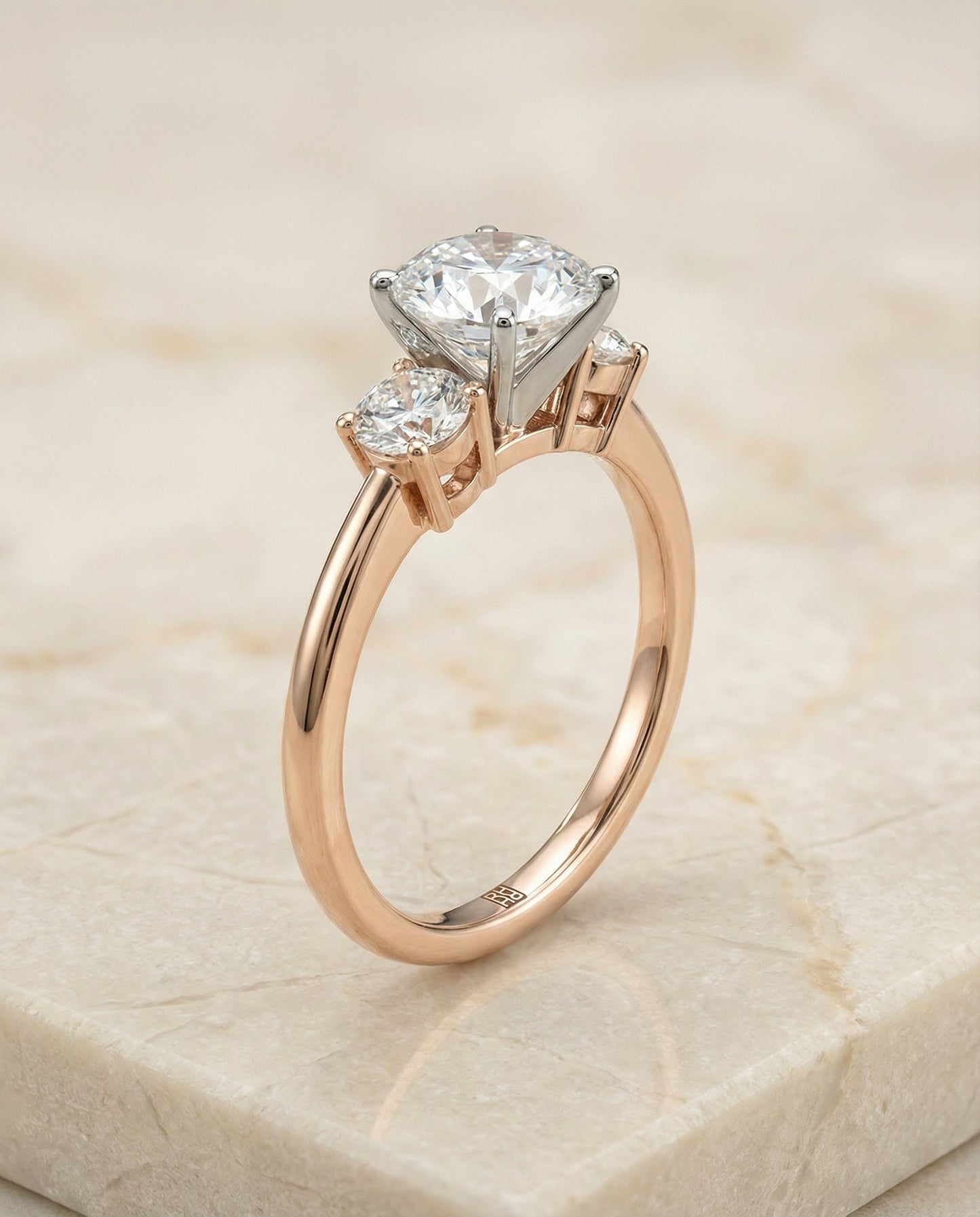 Round Brilliant, Classic Three Stone Round, in 14K Rose Gold, prong setting – front view | RockHer