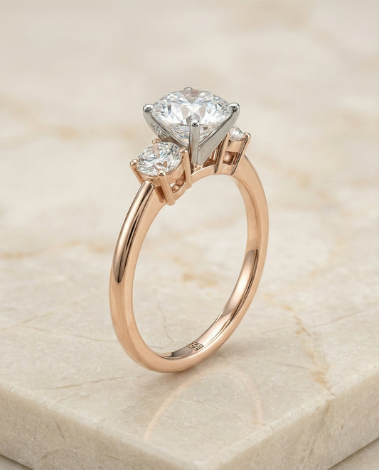 Round Brilliant, Classic Three Stone Round, in 14K Rose Gold, prong setting – front view | RockHer