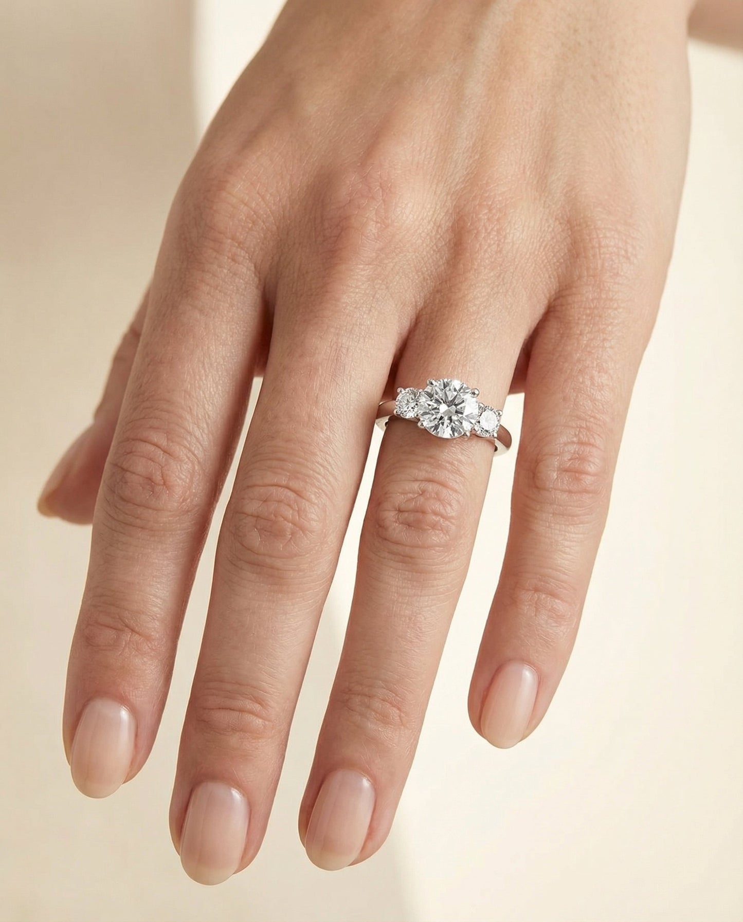 Round Brilliant, Classic Three Stone Round, in Platinum, prong setting – lifestyle shot | RockHer