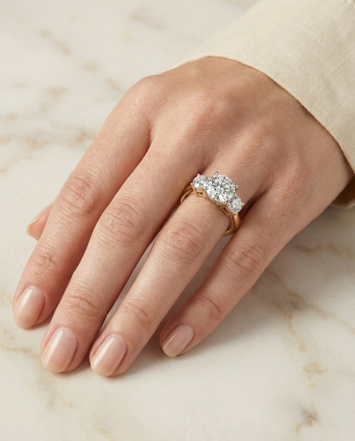Round Brilliant, Classic Three Stone Round, in 18K Yellow Gold, prong setting – lifestyle shot | RockHer