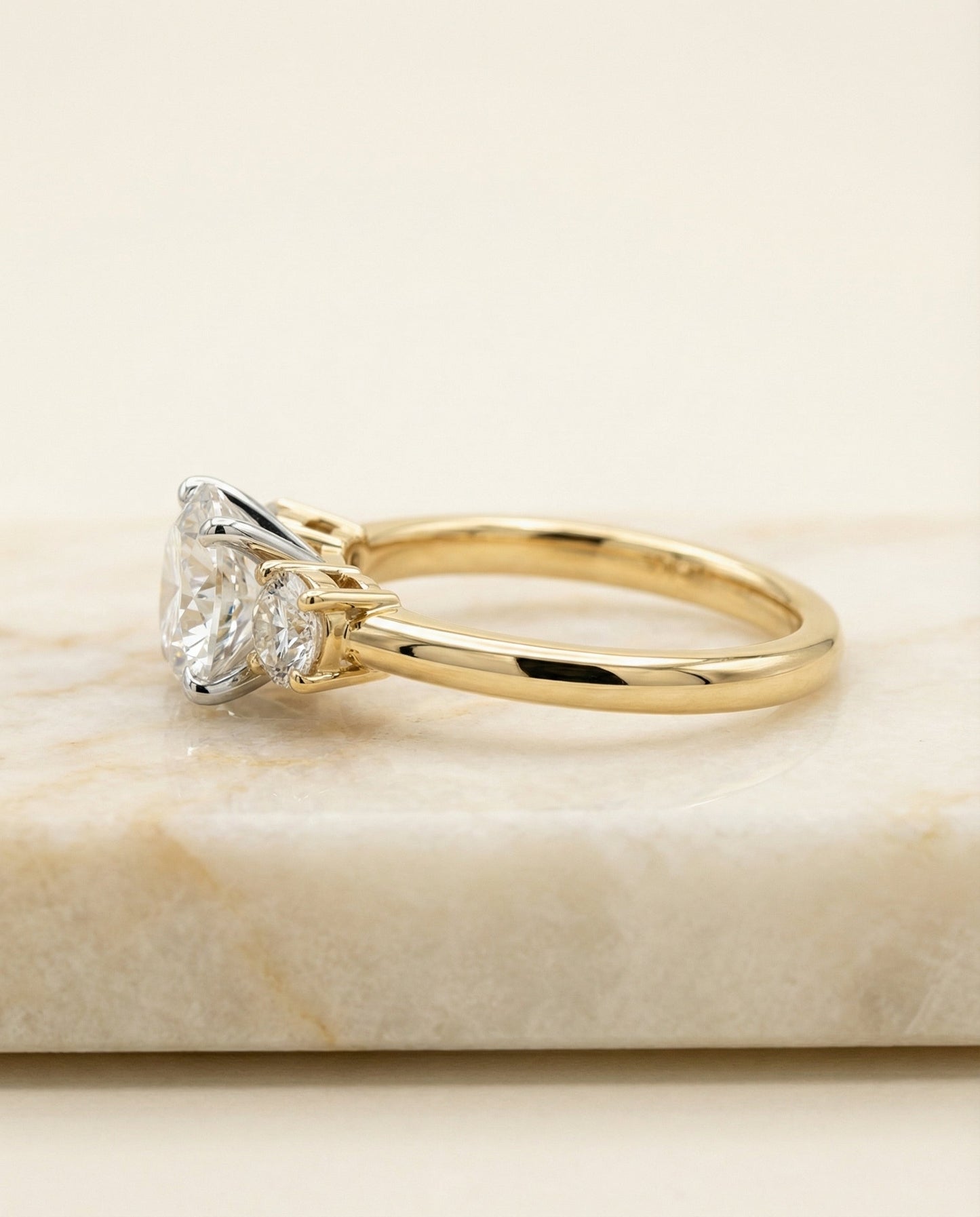 Round Brilliant, Classic Three Stone Round, in 18K Yellow Gold, prong setting – side profile | RockHer