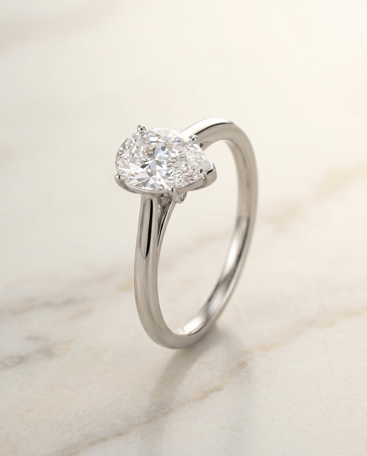 Comfort Fit Secret Stone Solitaire Pear Shape, in Platinum – front view | RockHer