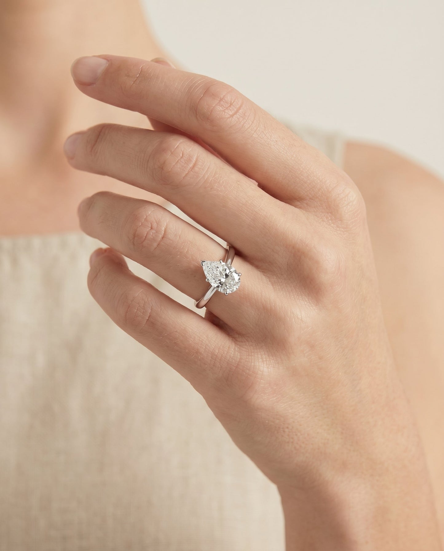 Comfort Fit Secret Stone Solitaire Pear Shape, in Platinum – lifestyle shot | RockHer