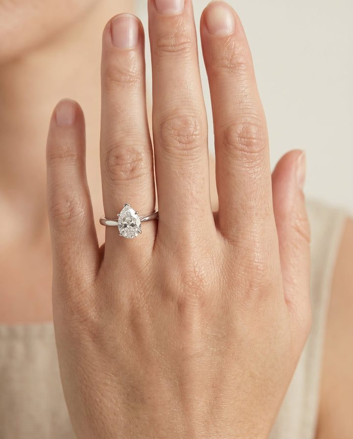 Comfort Fit Secret Stone Solitaire Pear Shape, in Platinum – lifestyle shot | RockHer