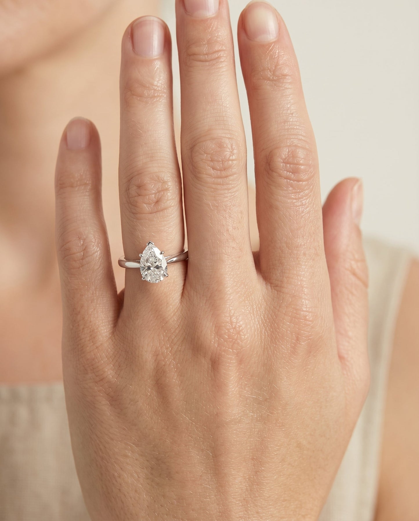 Comfort Fit Secret Stone Solitaire Pear Shape, in Platinum – lifestyle shot | RockHer