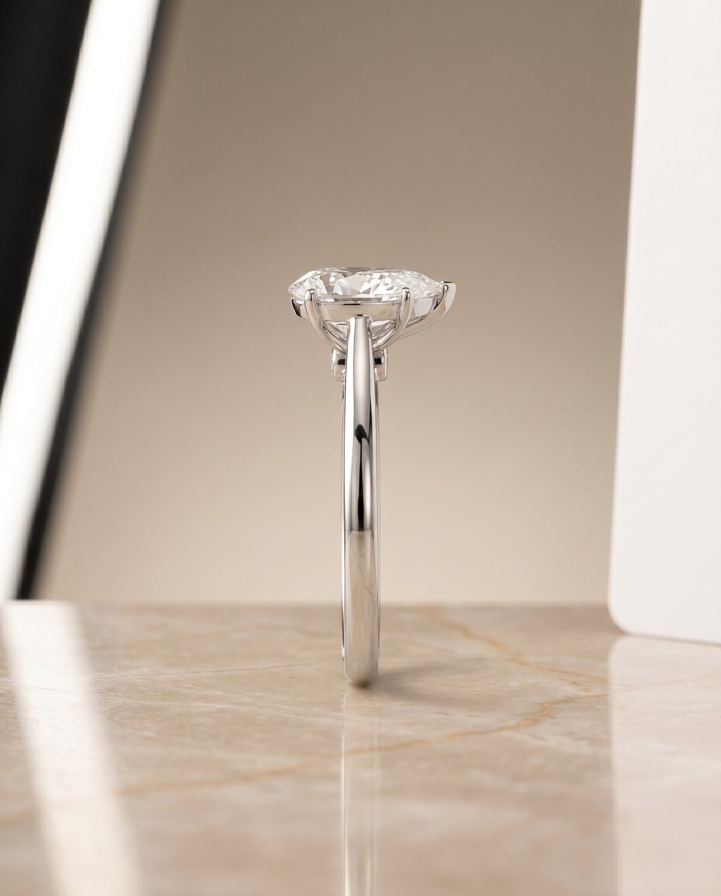 Comfort Fit Secret Stone Solitaire Pear Shape, in Platinum – side profile | RockHer
