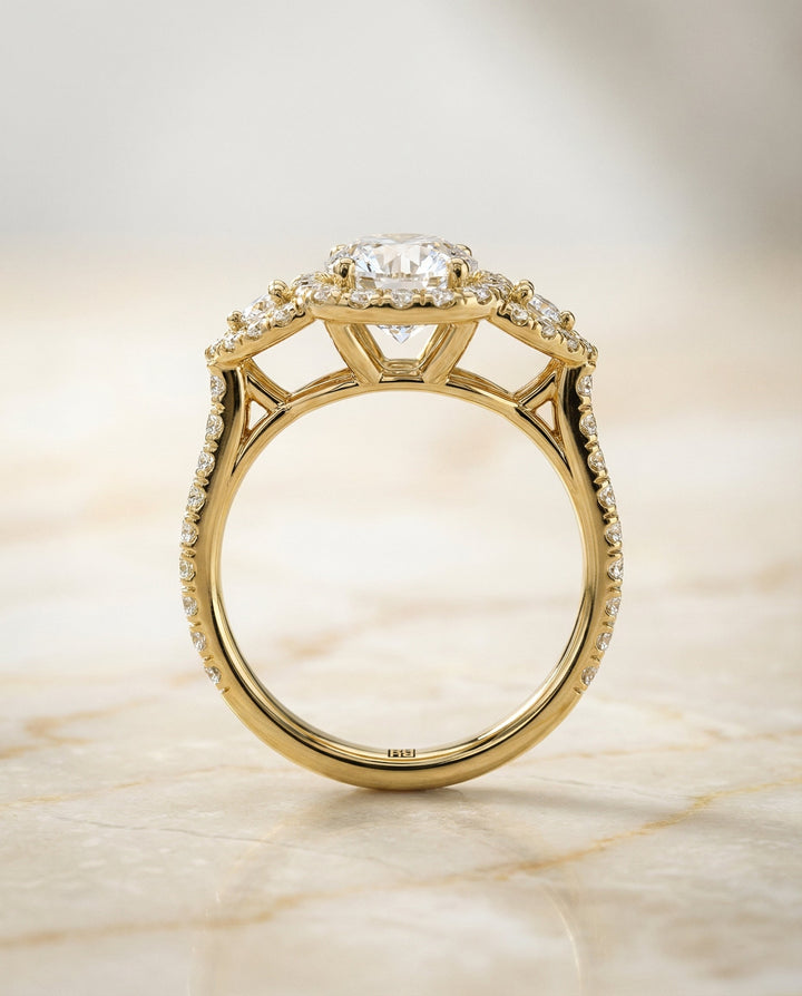 Round Brilliant, Delicate Three Stone Halo, in 18K Yellow Gold, pave setting – side profile | RockHer