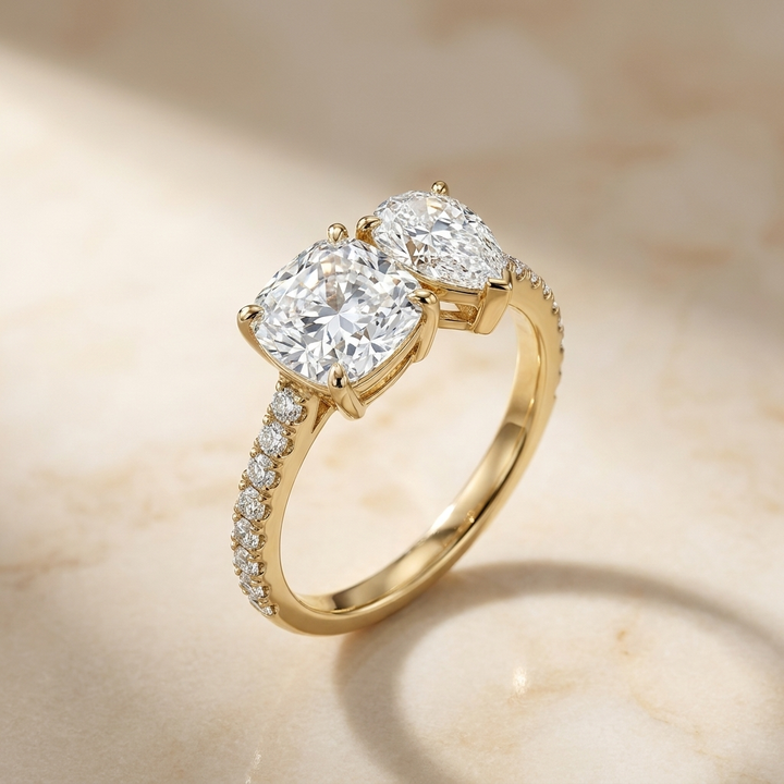 The Diana — Toi et Moi Cushion & Pear Pavé Band - Alt angle on warm marble