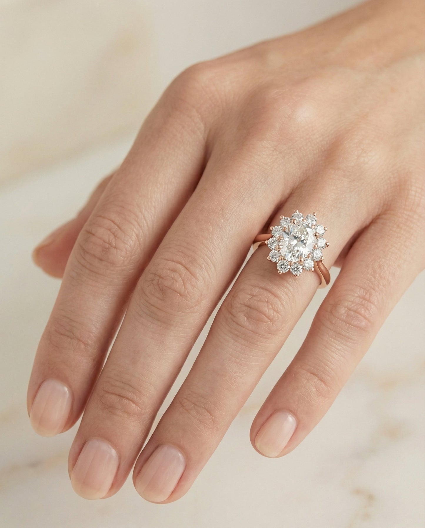 Eloise Select floral halo oval oval ring in 14K Rose Gold — on hand angled — RockHer