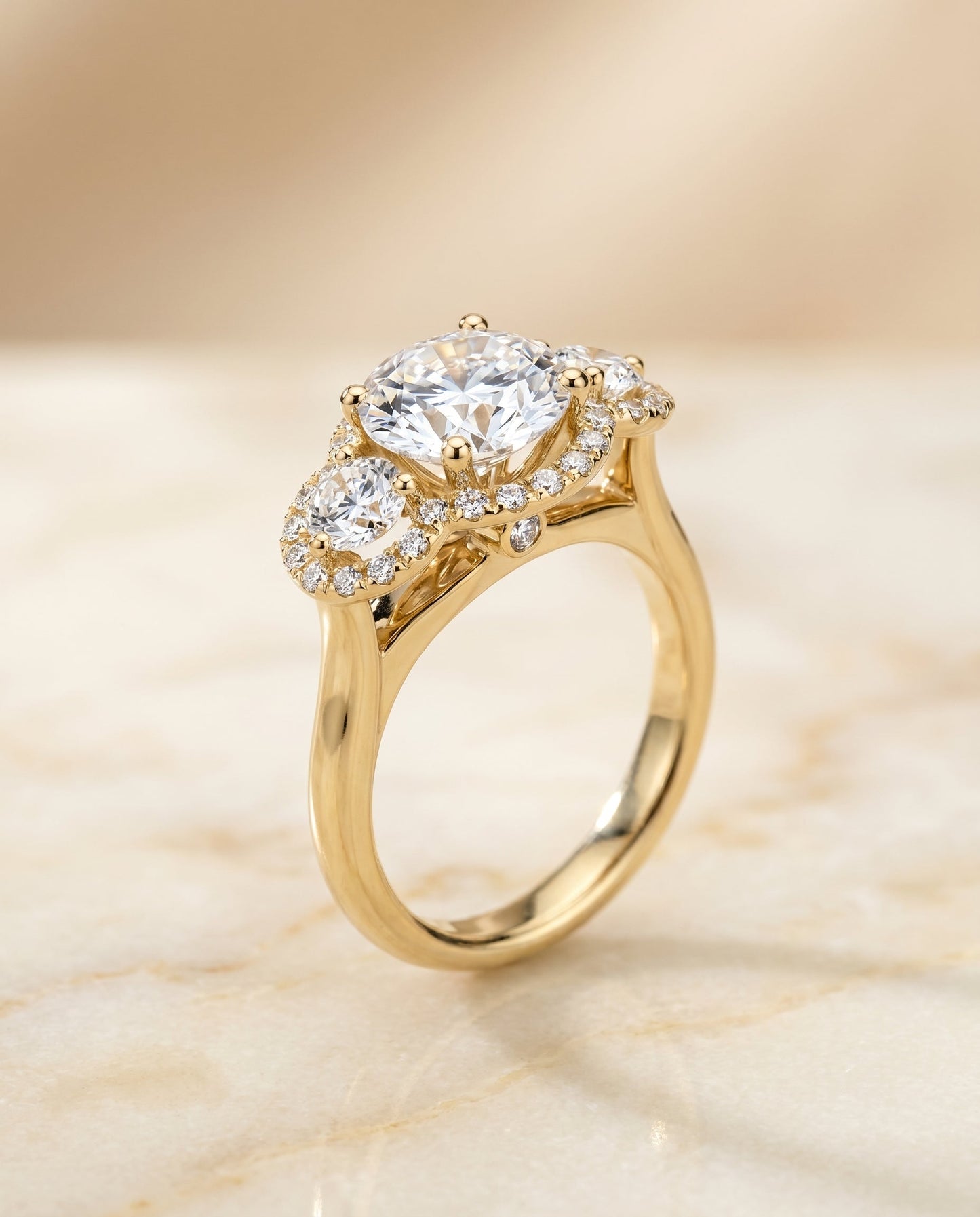 Round Brilliant, French Pavé Three Stone, in 18K Yellow Gold, prong setting – angled view | RockHer