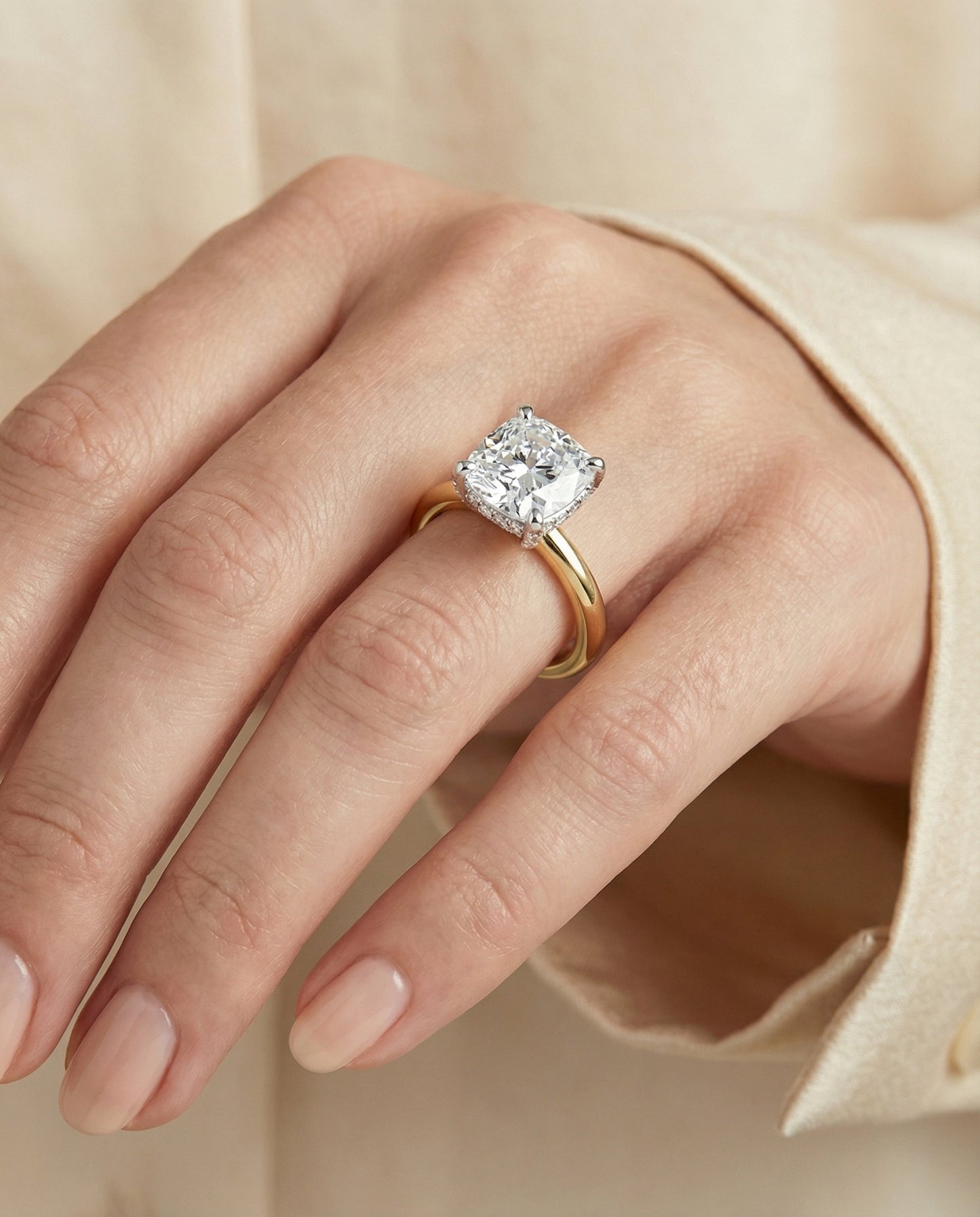 Hidden Pavé Basket Crown Solitaire Cushion, in 18K Yellow Gold – lifestyle shot | RockHer