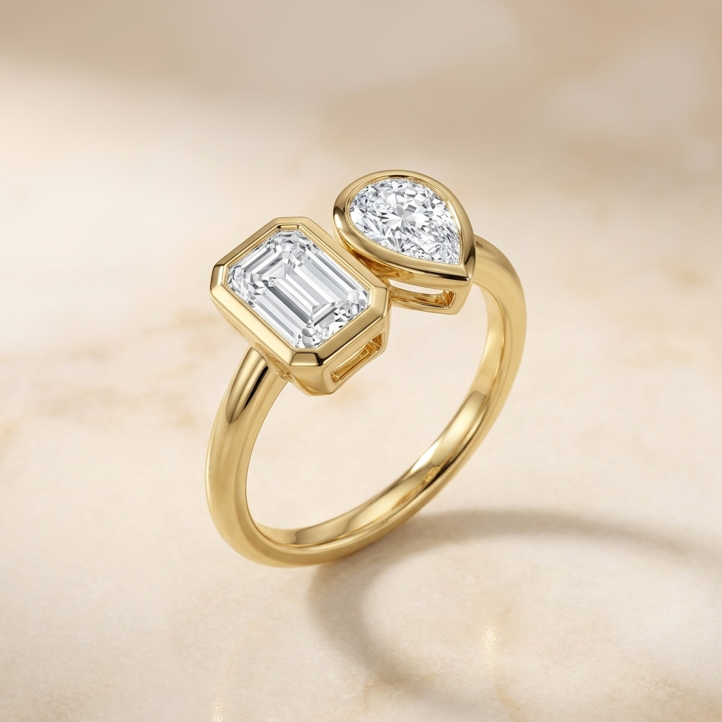 Josephine Toi et Moi Emerald & Pear Bezel Set Engagement Ring Setting - Alt angle on warm marble