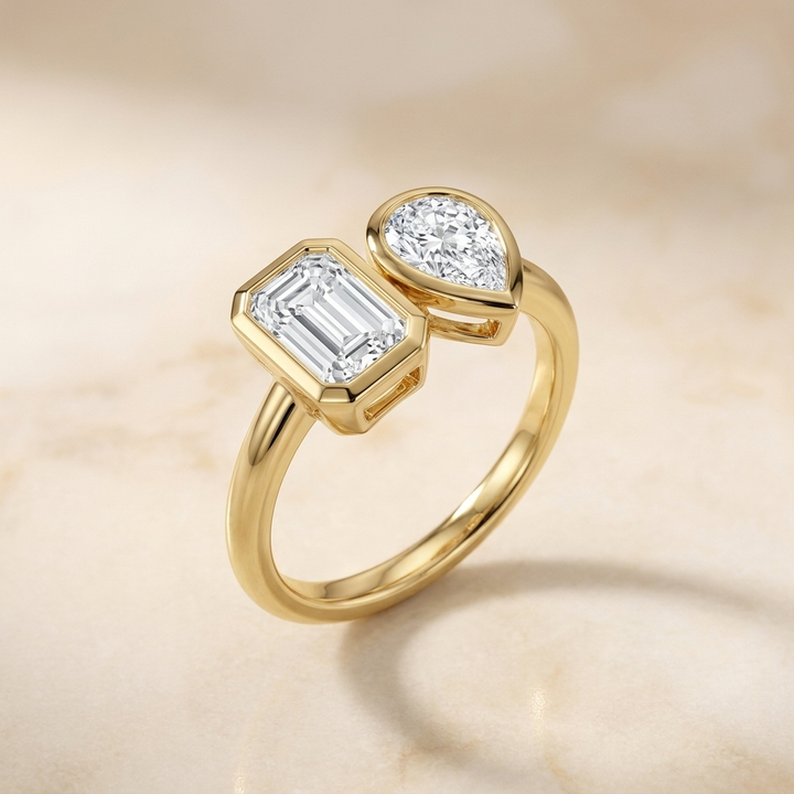 Josephine Toi et Moi Emerald & Pear Bezel Set Engagement Ring Setting - Alt angle on warm marble