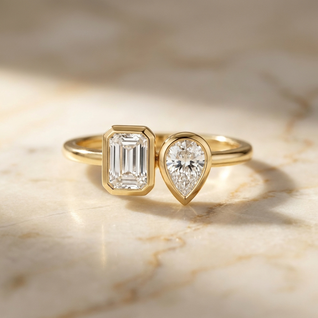 Josephine Toi et Moi Emerald & Pear Bezel Set Engagement Ring Setting - Hero on warm marble