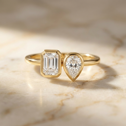 Josephine Toi et Moi Emerald & Pear Bezel Set Engagement Ring Setting - Hero on warm marble