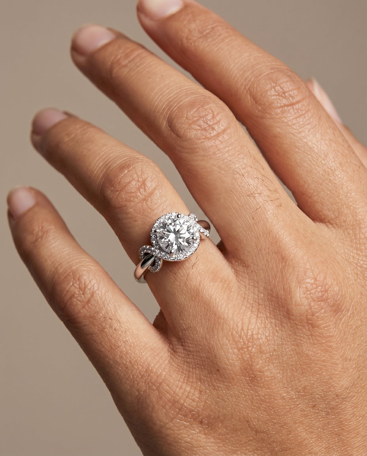 Round Brilliant, Love Knot Halo, in Platinum, pave setting – lifestyle shot | RockHer