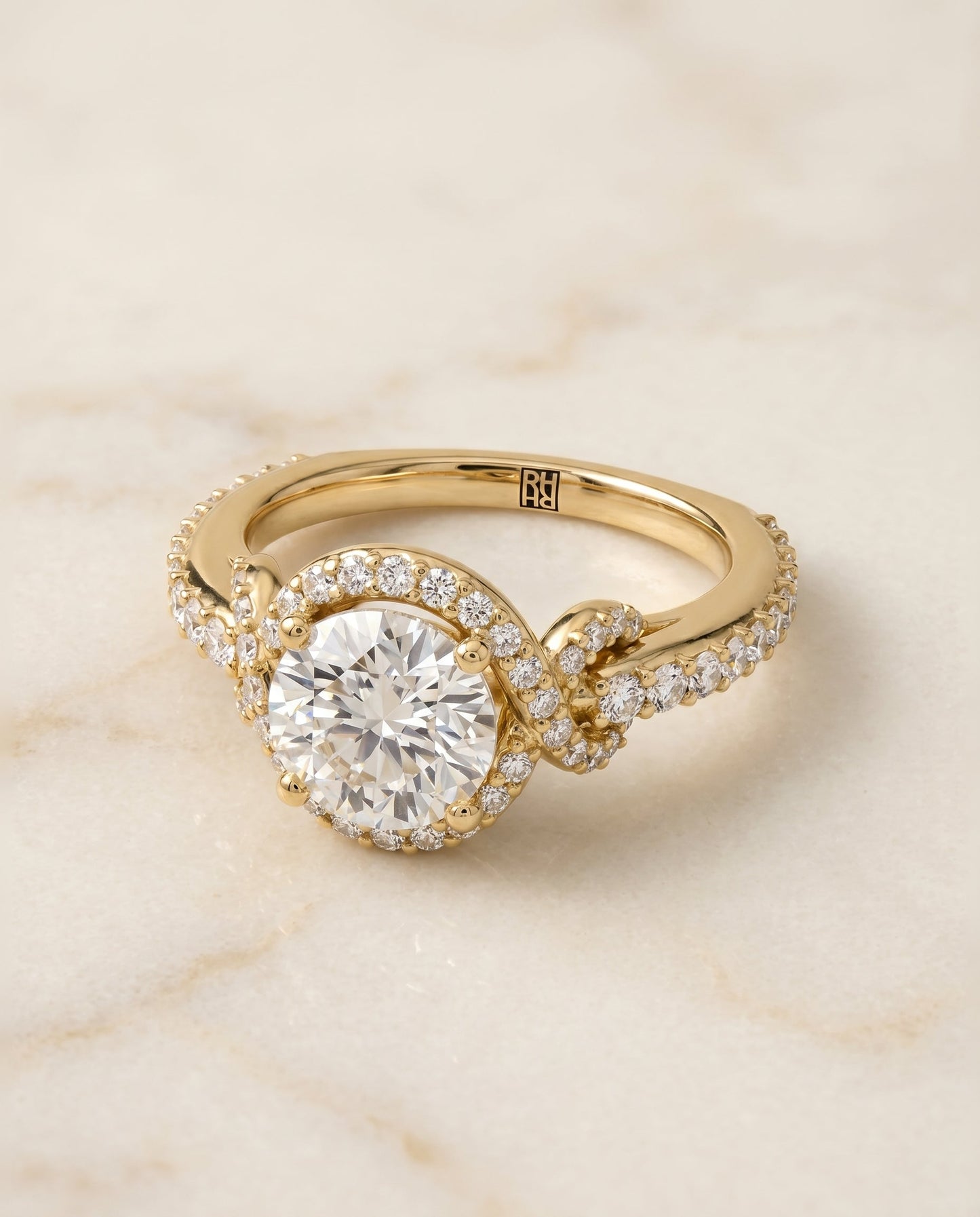 Round Brilliant, Love Knot Pavé Halo, in 18K Yellow Gold, pave setting – angled view | RockHer