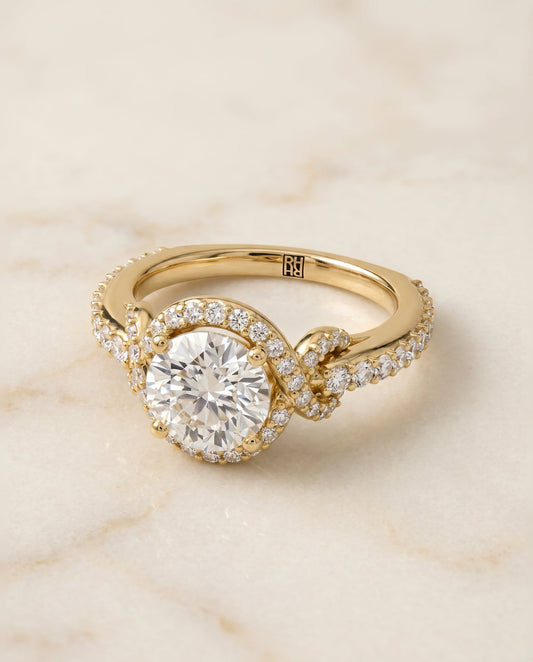 Round Brilliant, Love Knot Pavé Halo, in 18K Yellow Gold, pave setting – angled view | RockHer