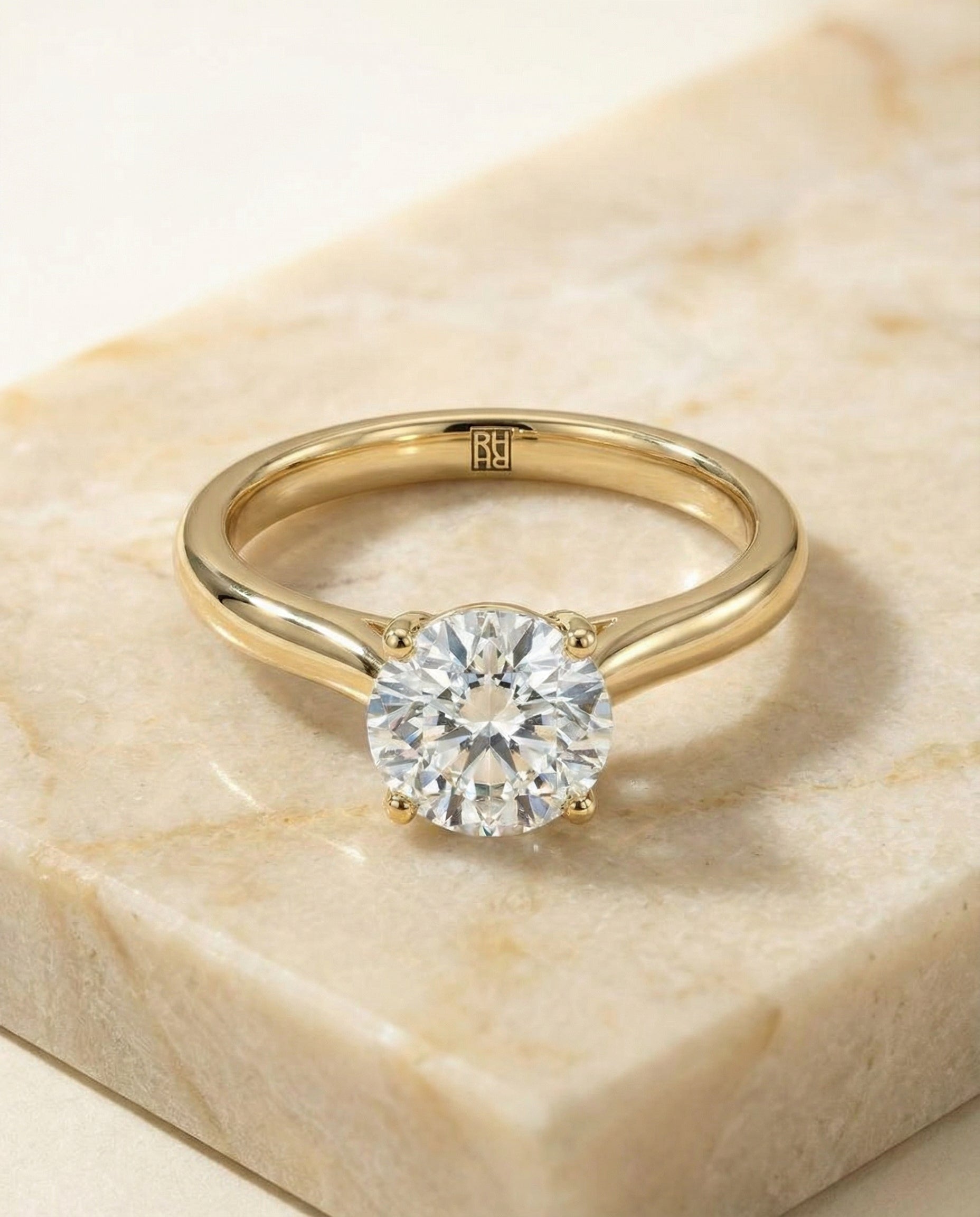 Round Brilliant, Pinched Cathedral Solitaire, in 18K Yellow Gold, prong setting – angled view | RockHer
