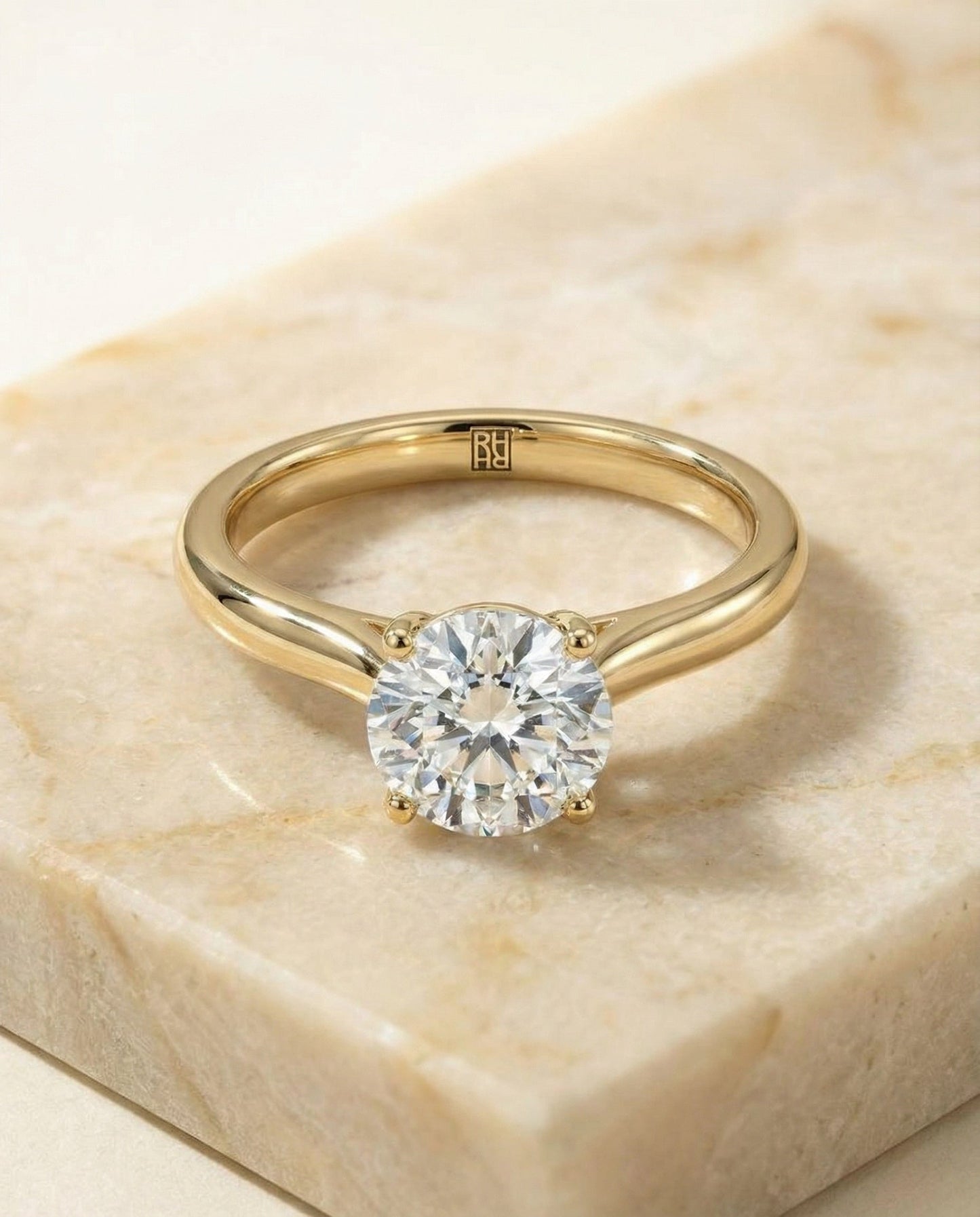 Round Brilliant, Pinched Cathedral Solitaire, in 18K Yellow Gold, prong setting – angled view | RockHer