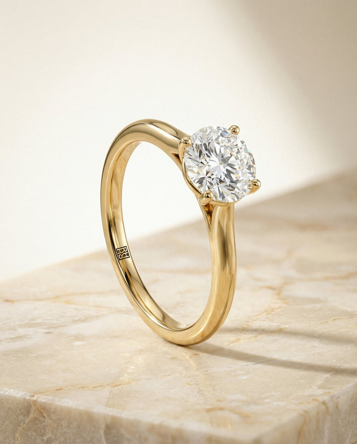 Round Brilliant, Pinched Cathedral Solitaire, in 18K Yellow Gold, prong setting – front view | RockHer