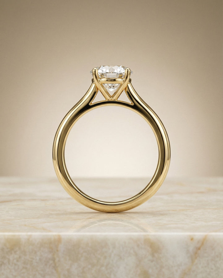Round Brilliant, Pinched Cathedral Solitaire, in 18K Yellow Gold, prong setting – side profile | RockHer