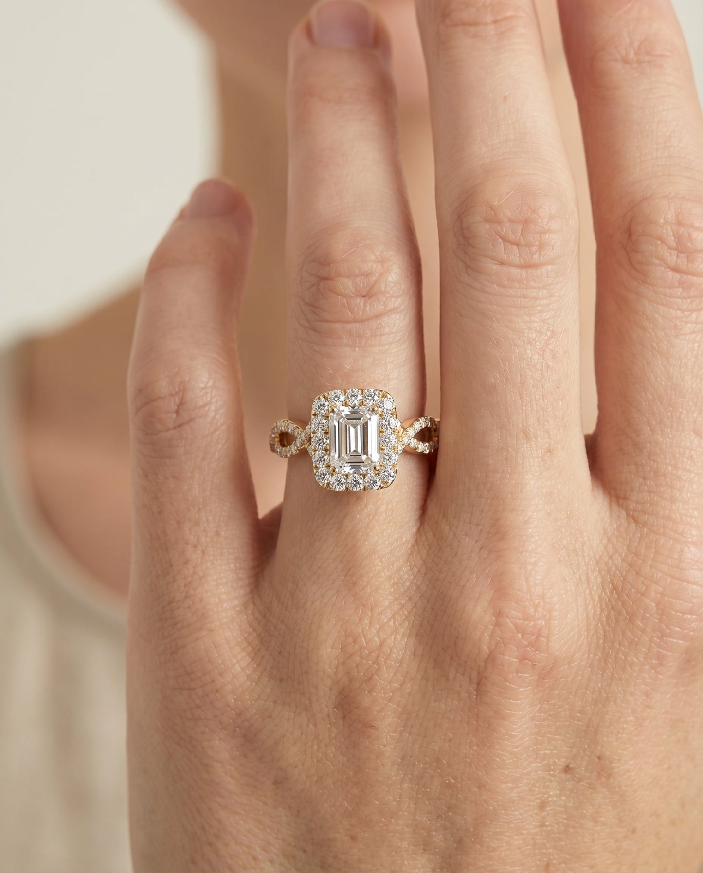 European Cut, Ribbon Twist Pavé Halo Emerald, in 18K Yellow Gold, pave setting – lifestyle shot | RockHer