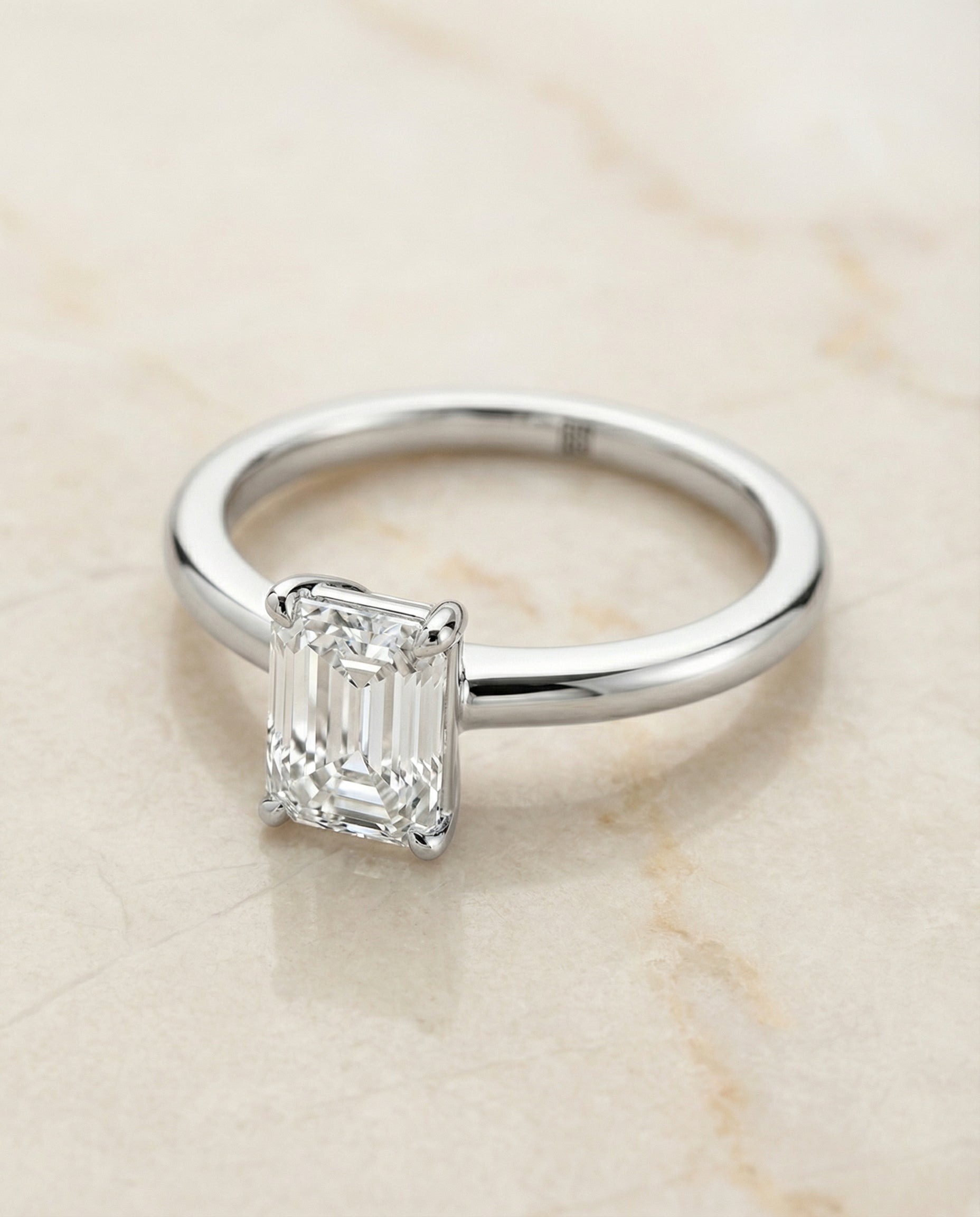European Cut, Round Comfort Fit Claw Prong Solitaire Emerald, in 18K White Gold – angled view | RockHer