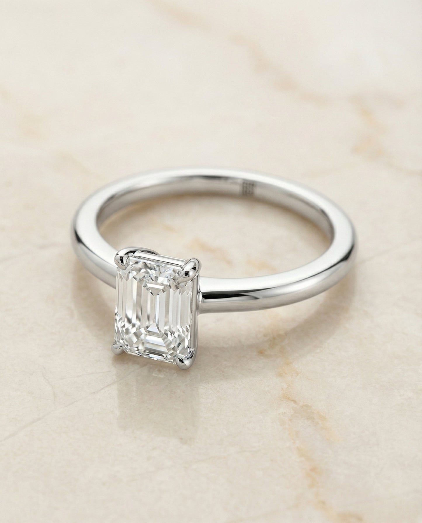 European Cut, Round Comfort Fit Claw Prong Solitaire Emerald, in 18K White Gold – angled view | RockHer
